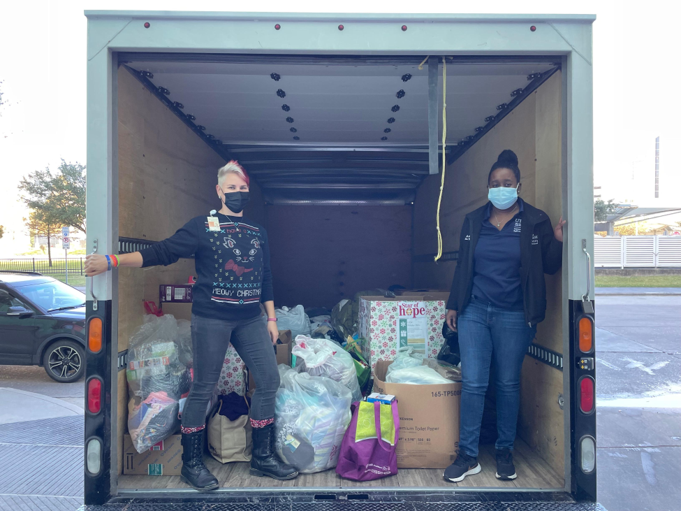 Members of UCSC Stand in the box truck needed for donations
